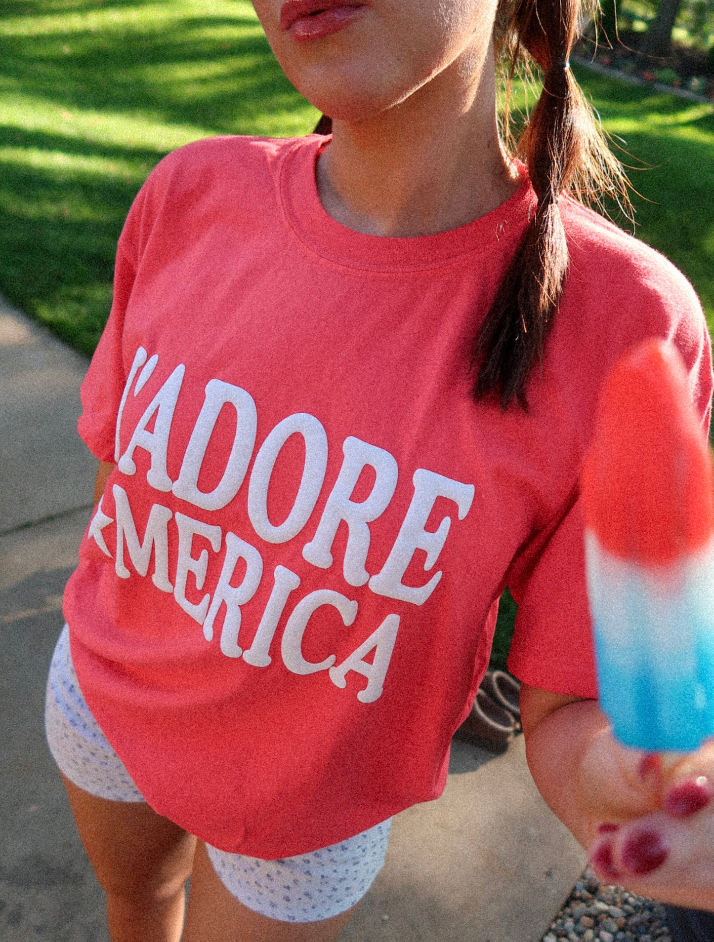 Close-up of J’ADORE *MERICA puff print with popsicle raised, shirt detail emphasized